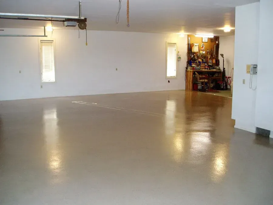 A large room with a tan floor and white walls