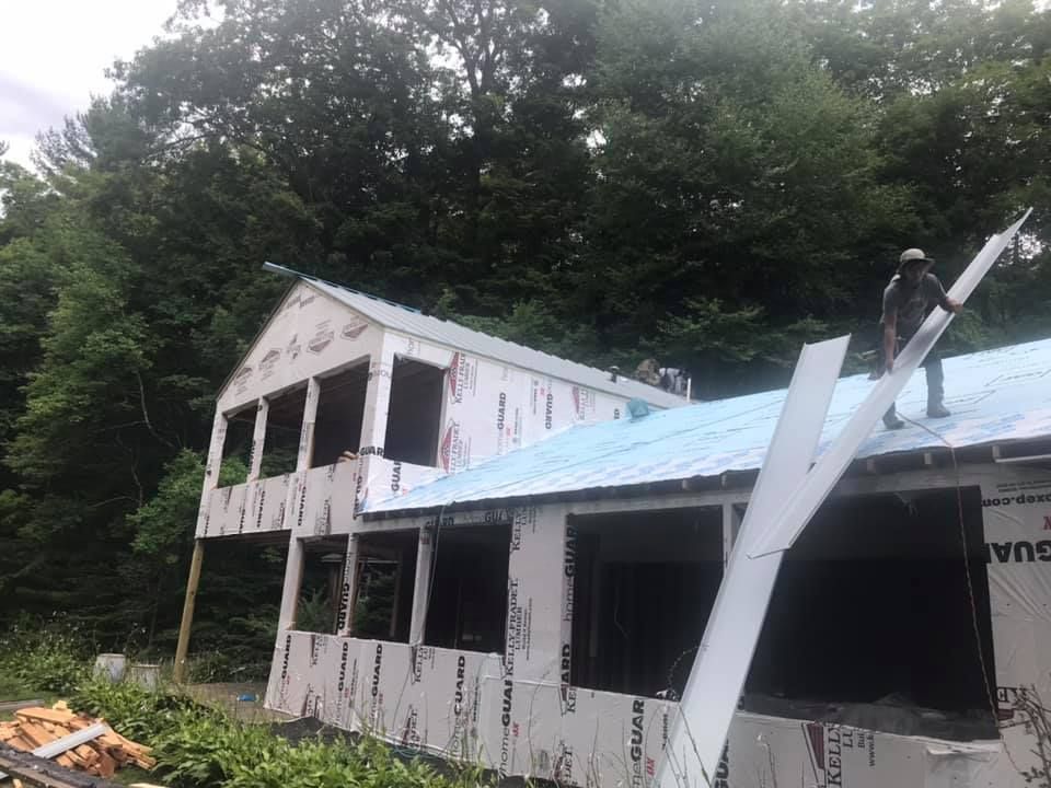 Man Is Standing On The Roof | New Milford, CT | Kent Hollow Siding LLC