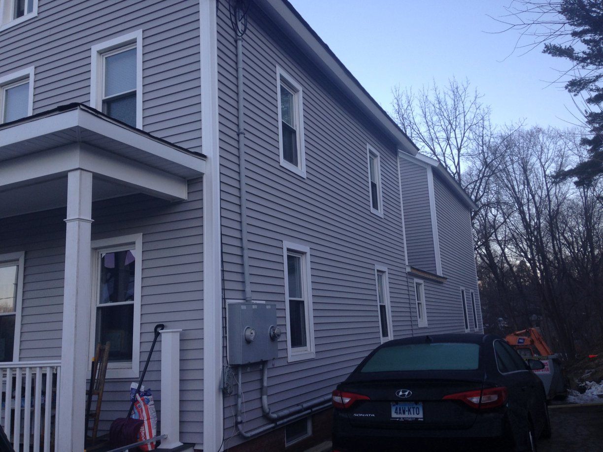 Black Car Is Parked In Front Of A House | New Milford, CT | Kent Hollow Siding LLC