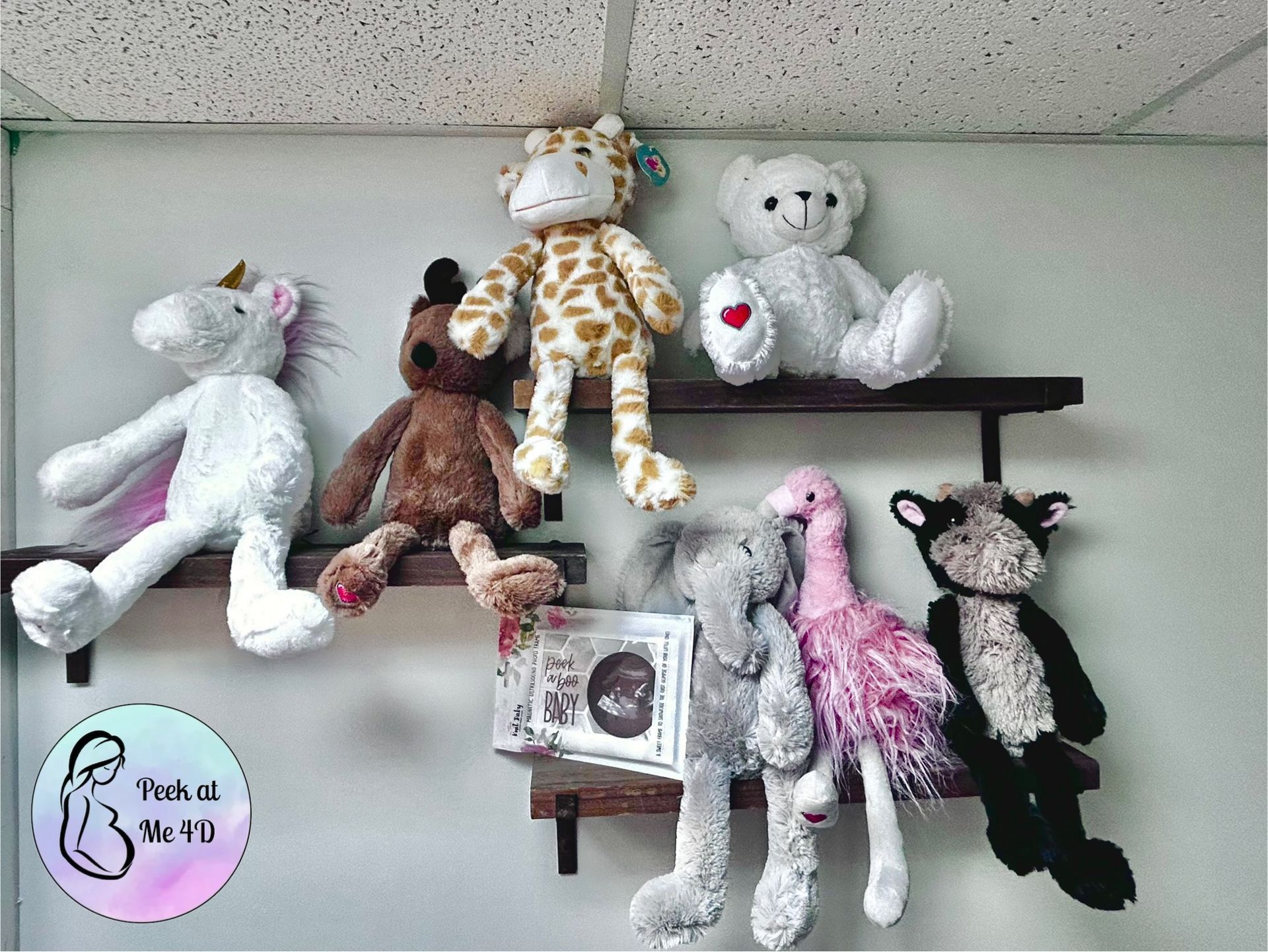 Woman getting an ultrasound scan, doctor examining abdomen with monitor displaying images in a medical office.