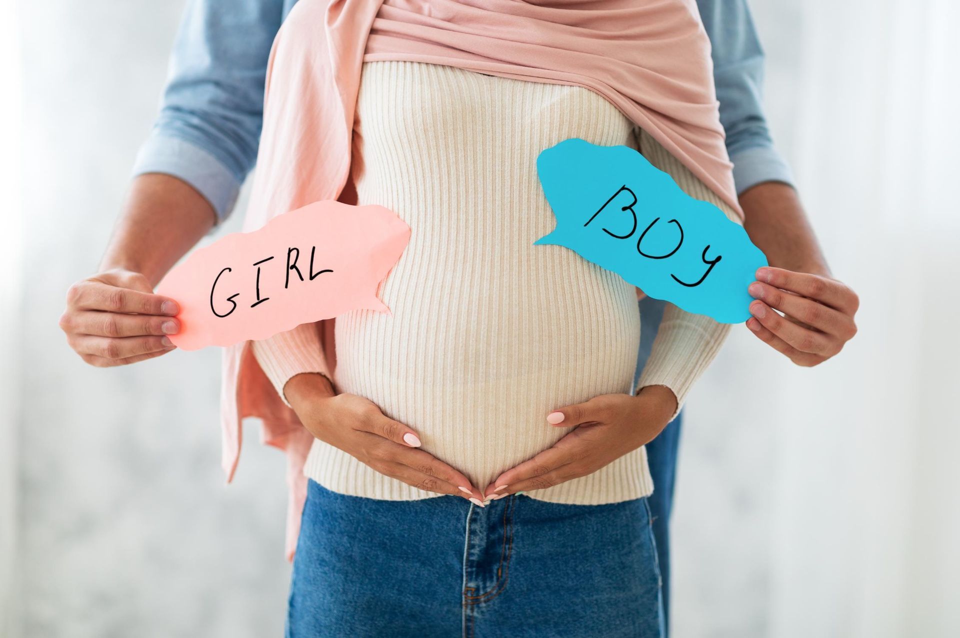 Pregnant woman with partner holding 
