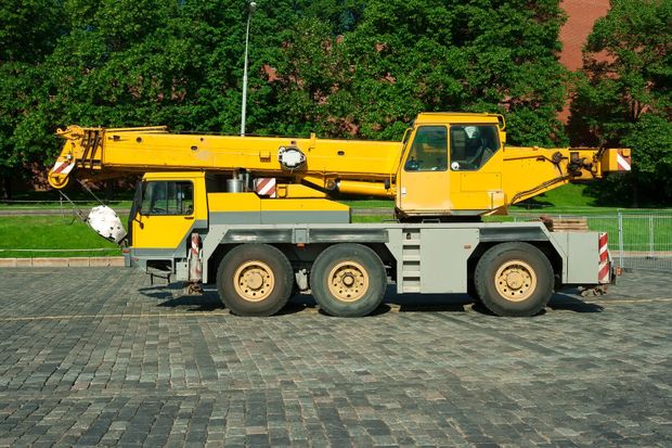 a yellow portable crane truck