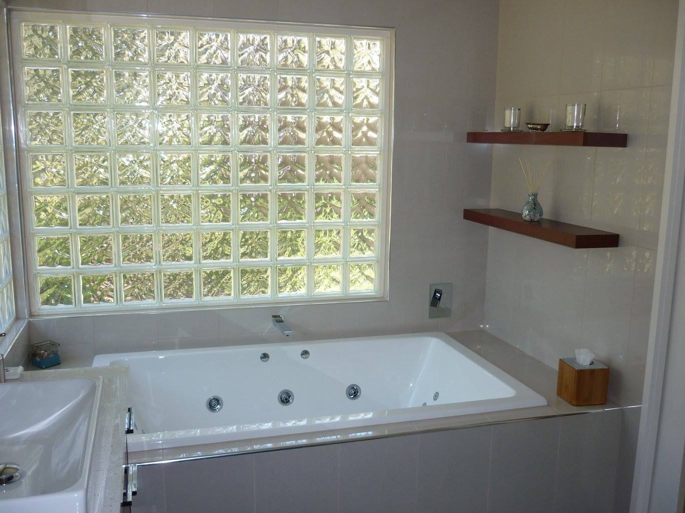 A bathroom with a jacuzzi tub and a window