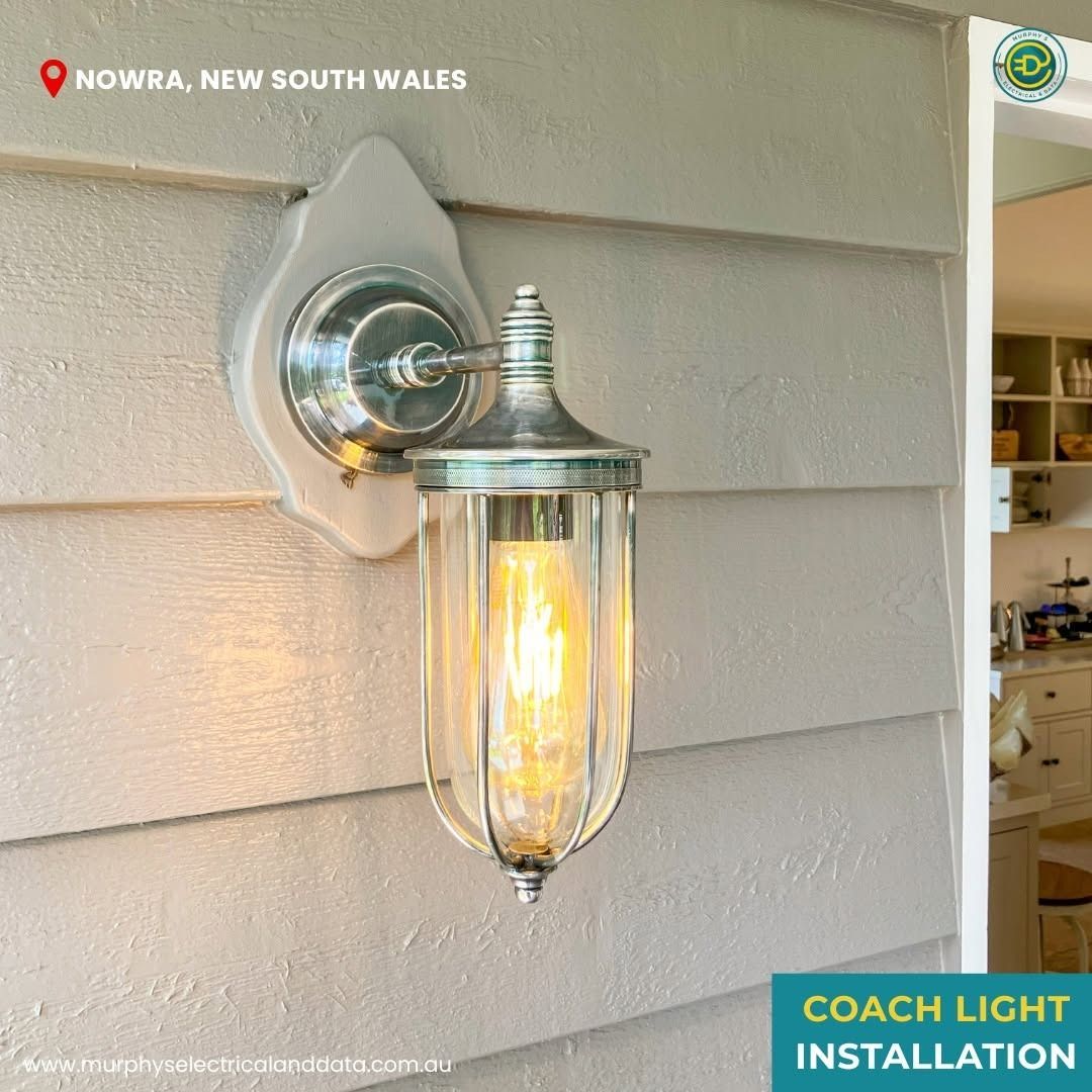 Coach light installation in Nowra, New South Wales. Exterior lamp with clear glass and metal fixture.