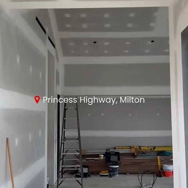 Interior under construction at Princess Highway, Milton. Drywall, ladder, and tools visible.