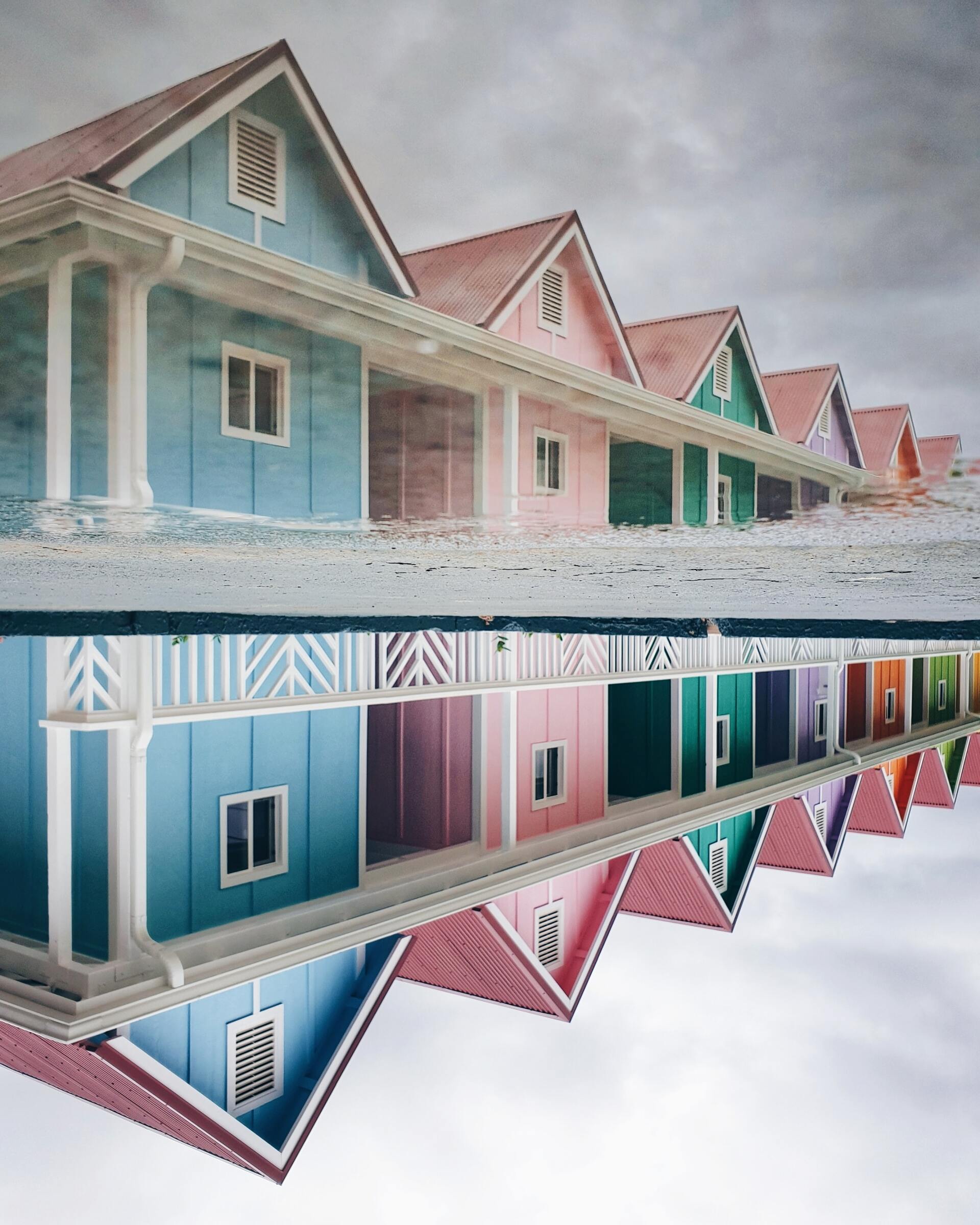 Row of houses in pastel colors with mirror image reflection
