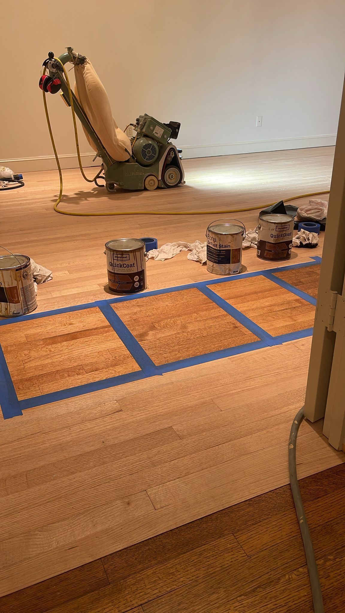A machine is being used to sand a wooden floor.