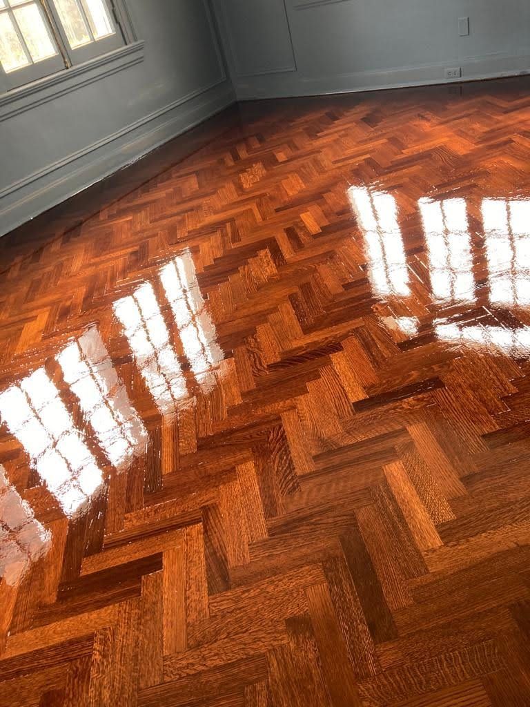 A room with a wooden floor and a herringbone pattern.