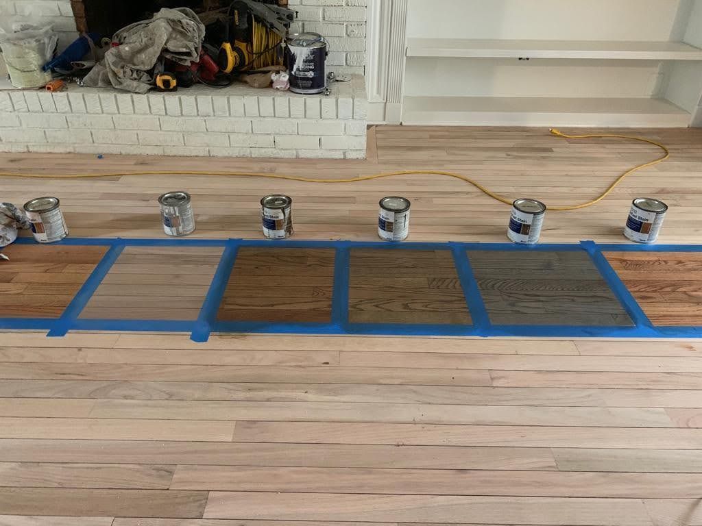 A wooden floor with buckets of paint on it