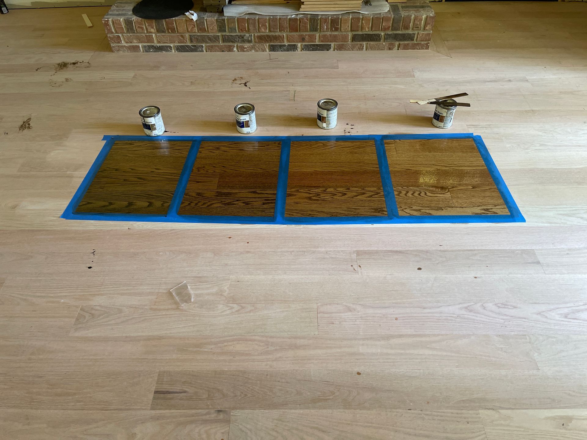 A wooden floor with four pieces of plywood on it