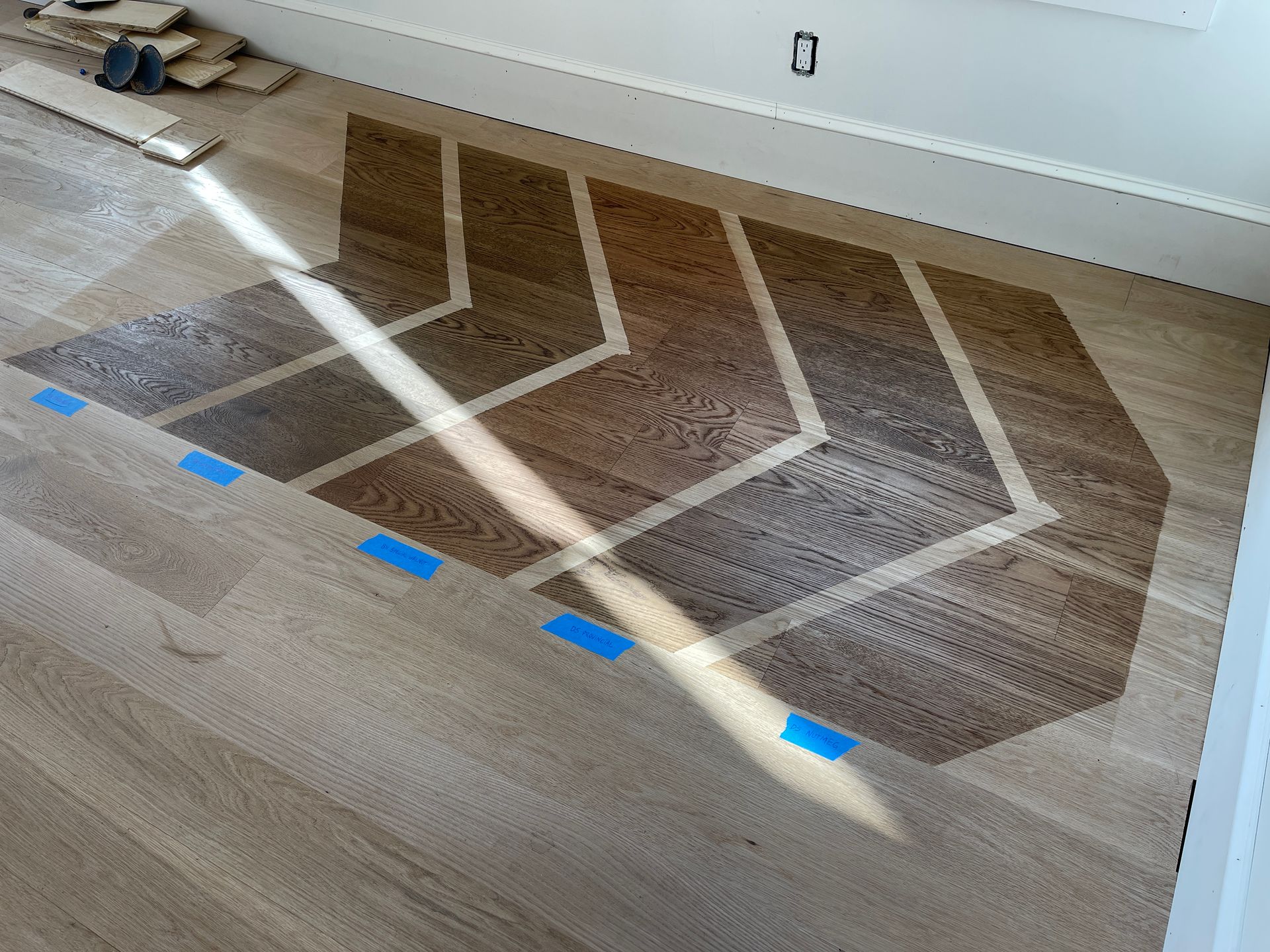 A wooden floor with a chevron pattern painted on it.