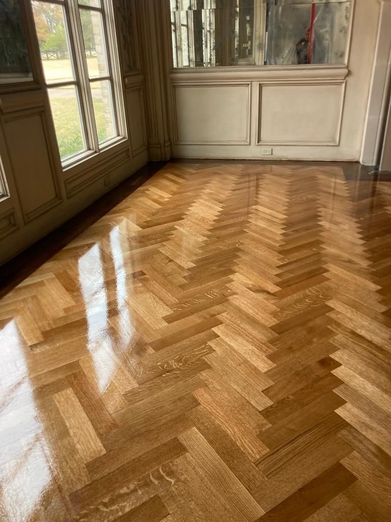 A room with a wooden floor and a herringbone pattern.