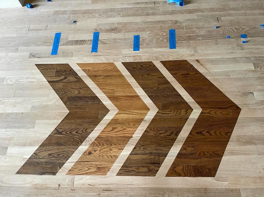 A wooden floor with three arrows painted on it