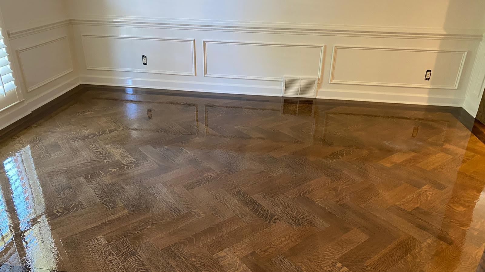A room with a herringbone pattern on the floor.