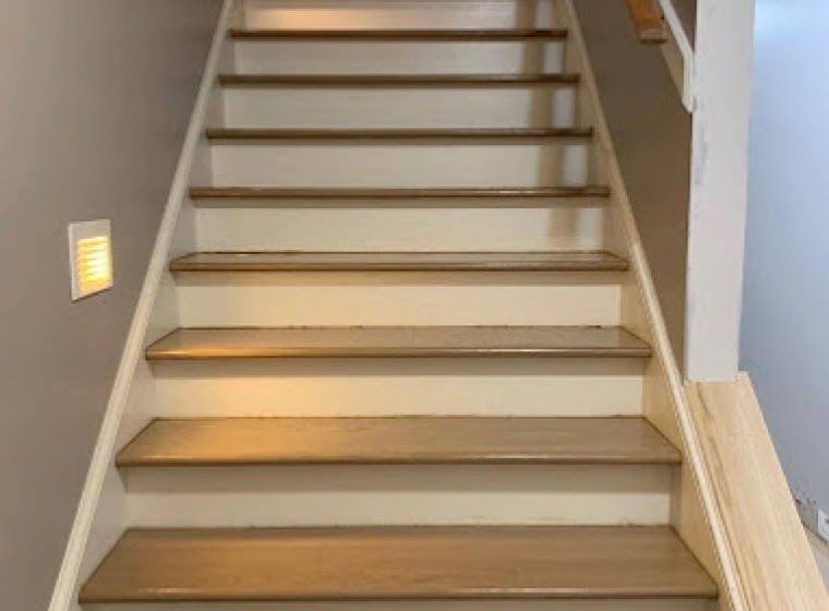 A set of wooden stairs leading up to the second floor of a house.