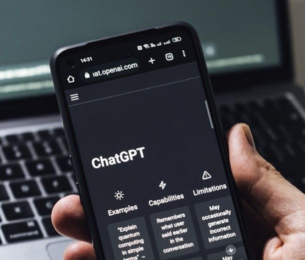 a person is holding a cell phone that says chatgpt on the screen