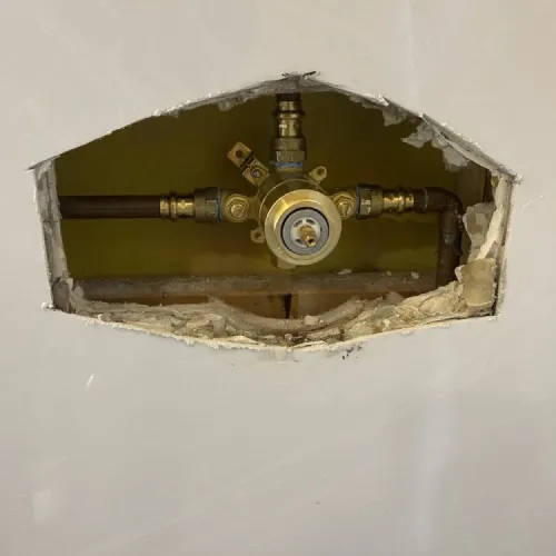 A hole in the wall with a faucet in it | The Duke Of Plumbing