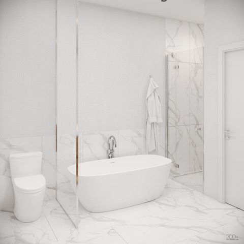 Modern white marble bathroom with a freestanding tub, toilet, shower, and glass partition