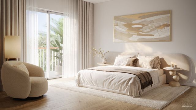 Sunlit minimalist bedroom with a beige bed, lounge chair, and sheer curtains by a balcony door