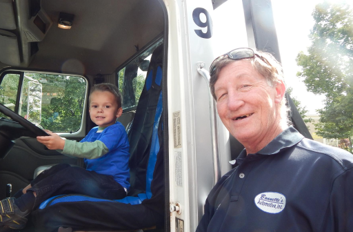 child sitting in driver seat of car | Bonnettes Automotive Inc