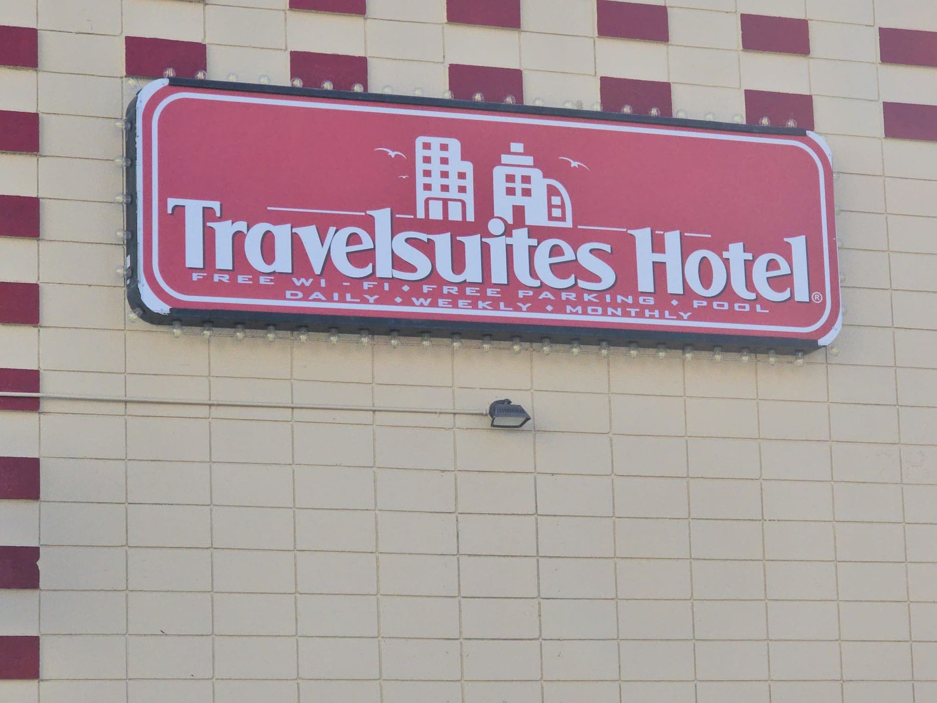 A travelsuites hotel sign on the side of a building