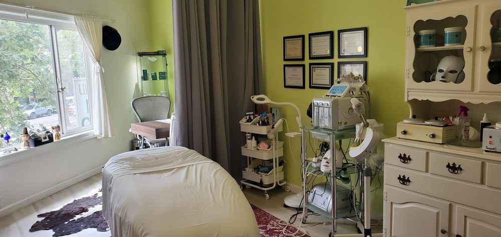 A room with a bed , dresser , cabinets and a window.