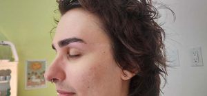A close up of a person 's face with their eyes closed.