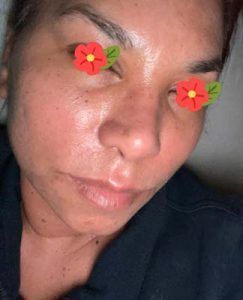 A close up of a woman 's face with flowers on her eyes.
