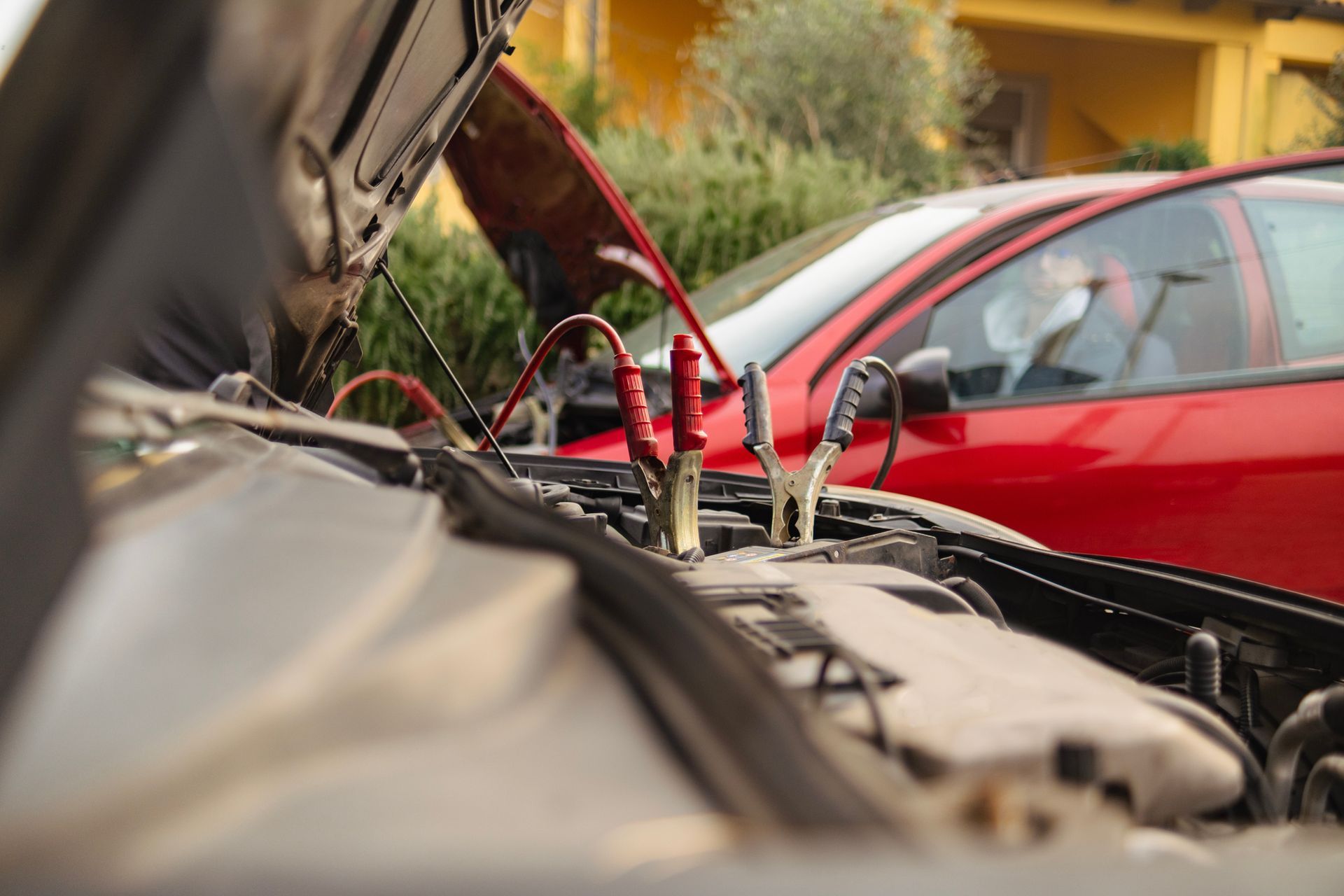 A man is charging a car with a jump starter - Hialeah, FL - Servicio De Gruas Towing Services