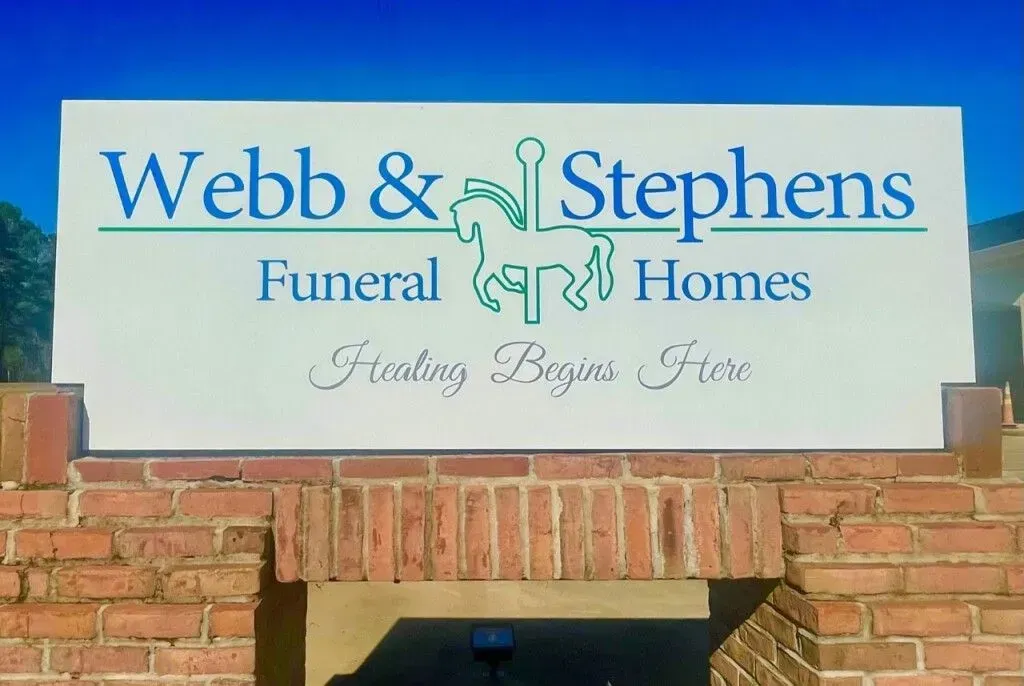 Webb & Stephens Funeral Homes sign above a brick building entrance