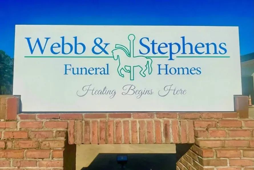 Webb & Stephens Funeral Homes sign above a brick building entrance