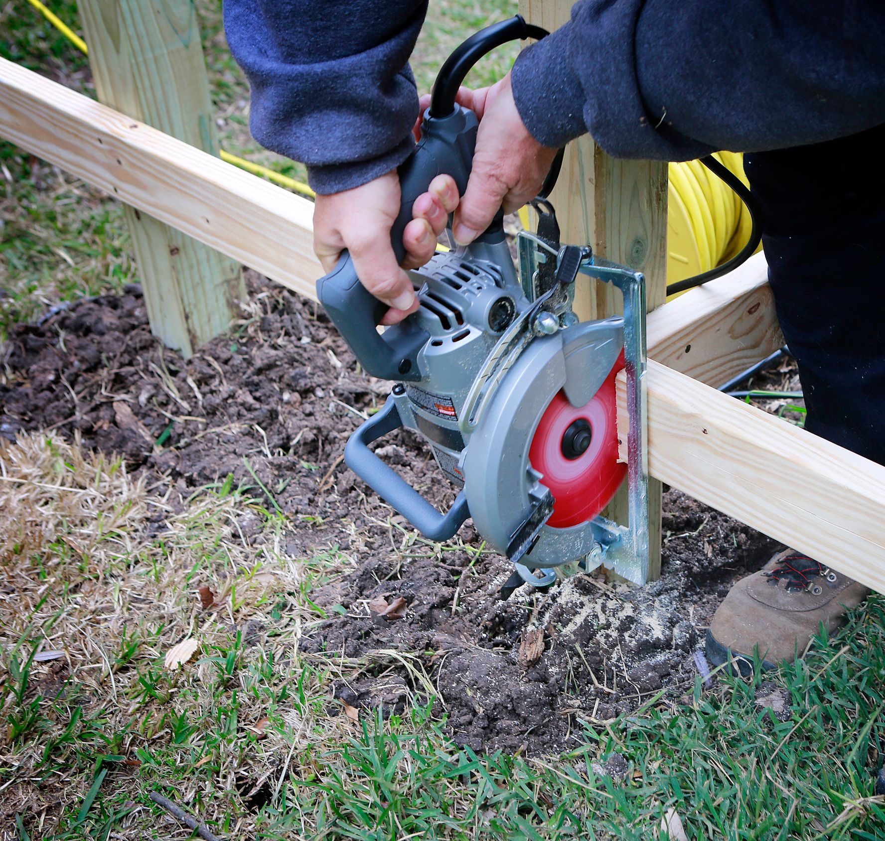 A person is using a circular saw to cut a piece of wood