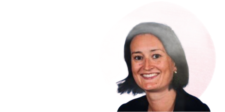 Woman with a smile, wearing a dark top, with a blurred background.