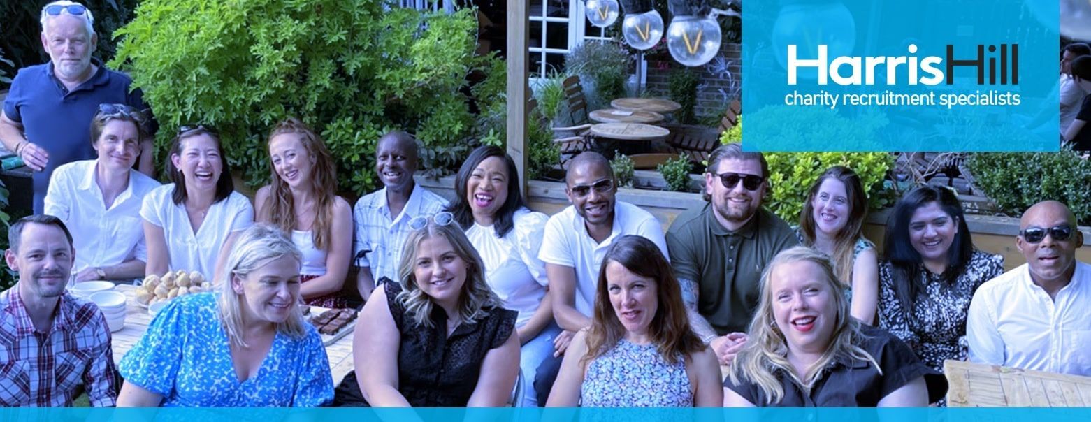Group of people smiling, posing outdoors; 