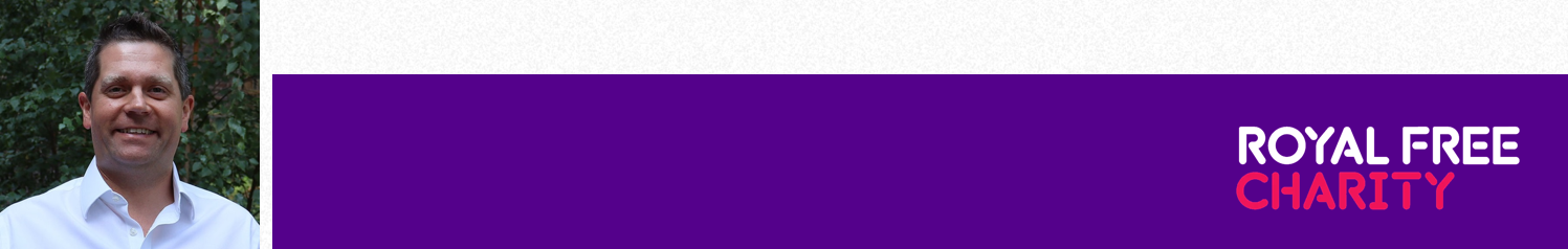 Man smiling, wearing a white shirt, in front of a purple Royal Free Charity banner.