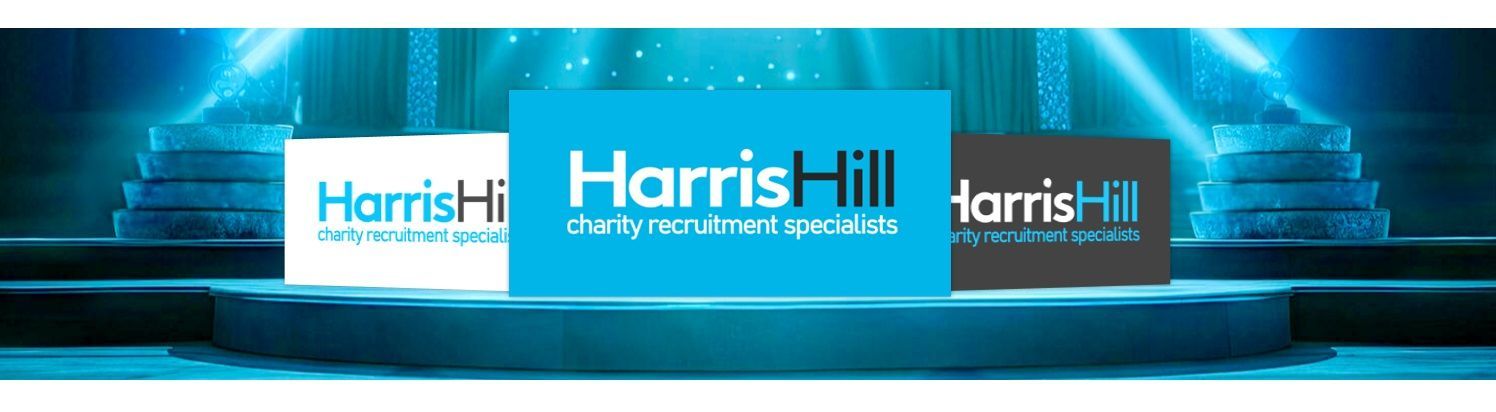 Harris Hill logo variations on a stage with a blue, glowing background.