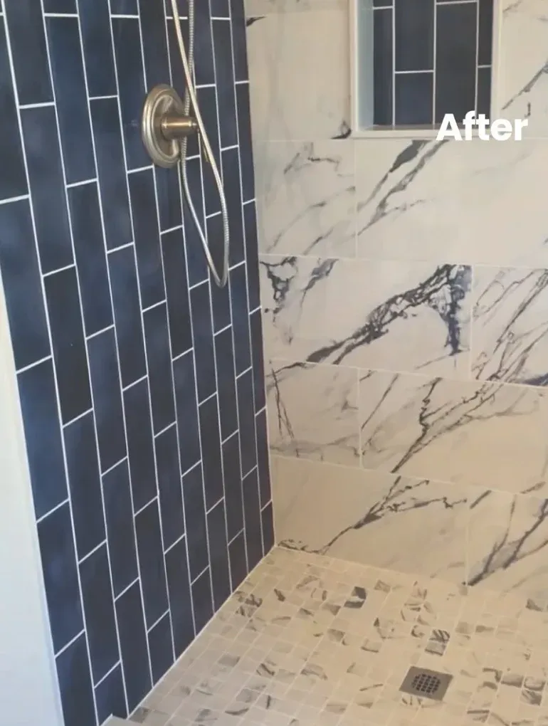 Modern shower with blue brick-laid tiles and marble walls; small window, stone floor.