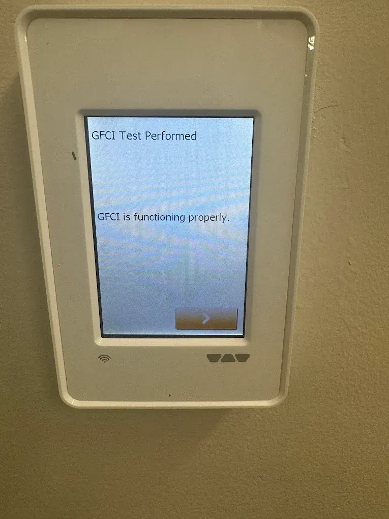 White wall-mounted touch screen displaying error messages: 