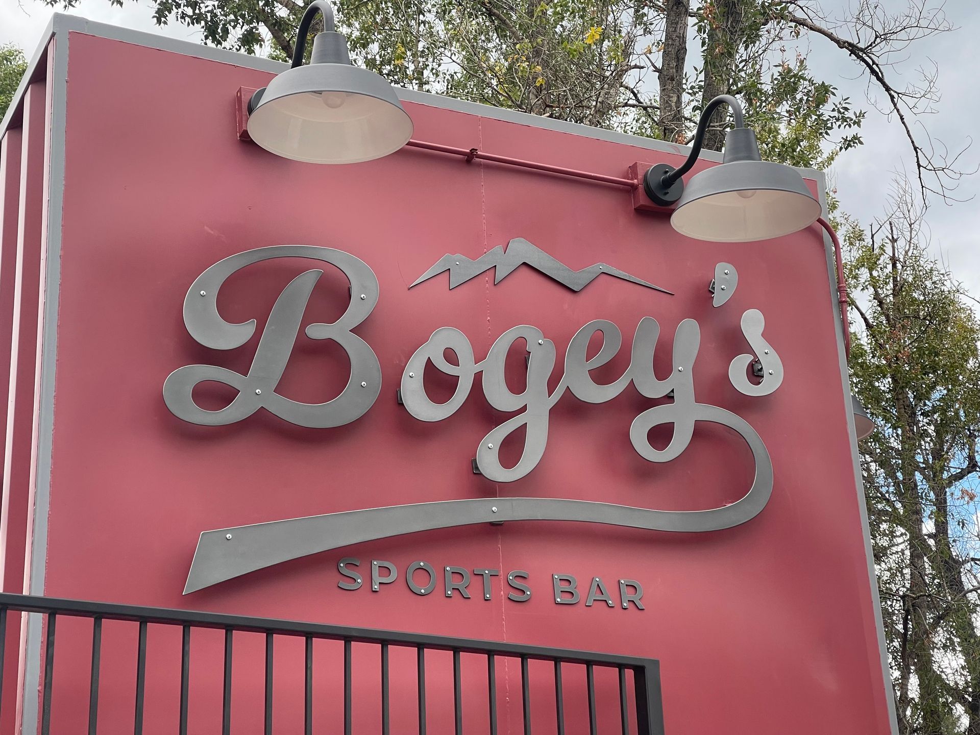 A red sign that says bogey 's sports bar on it