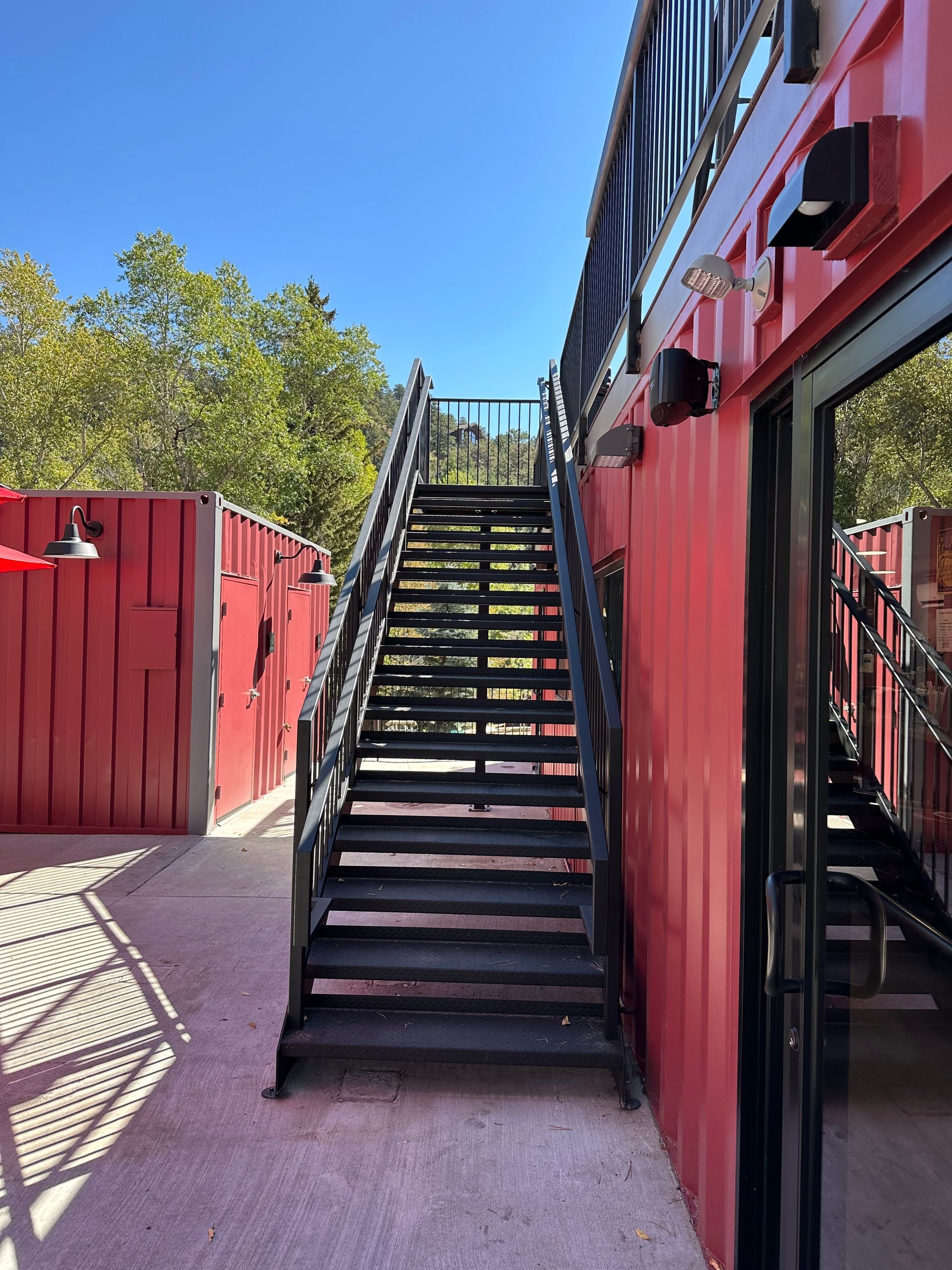 A set of stairs leading up to a red building