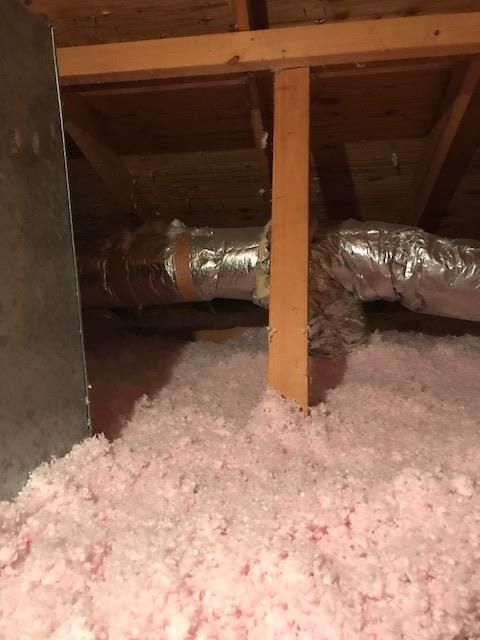 There is a lot of pink insulation in the attic.