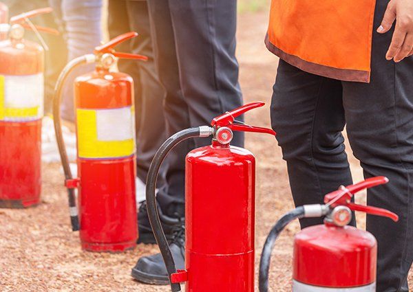 Row of Fire Extinguisher During Training — Milwaukee, WI — Accurate Recharge and Fire Suppression