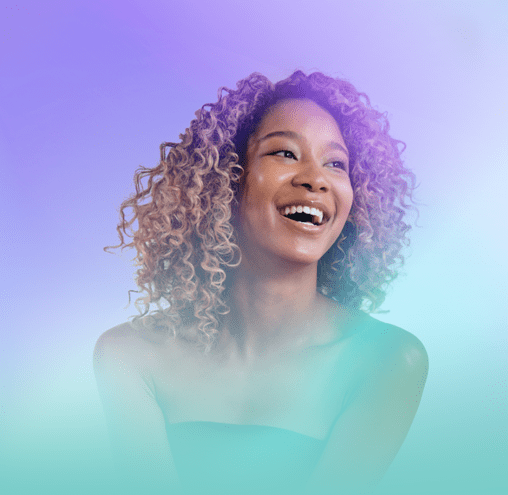 A woman with curly hair is smiling in front of a purple and blue background.
