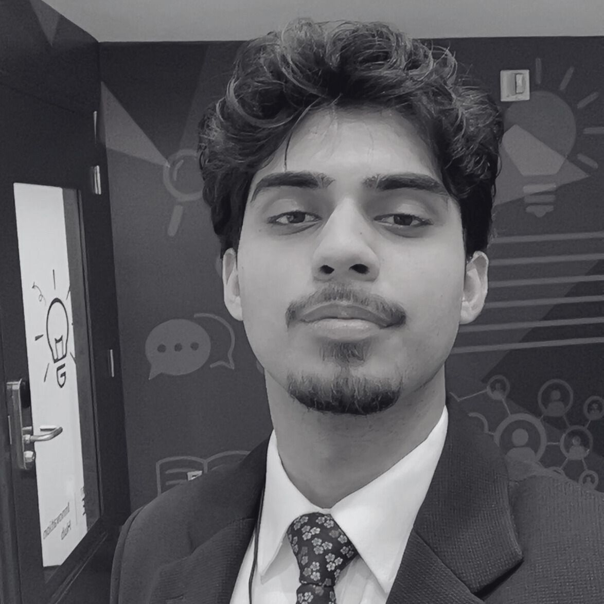 A black and white photo of a man in a suit and tie