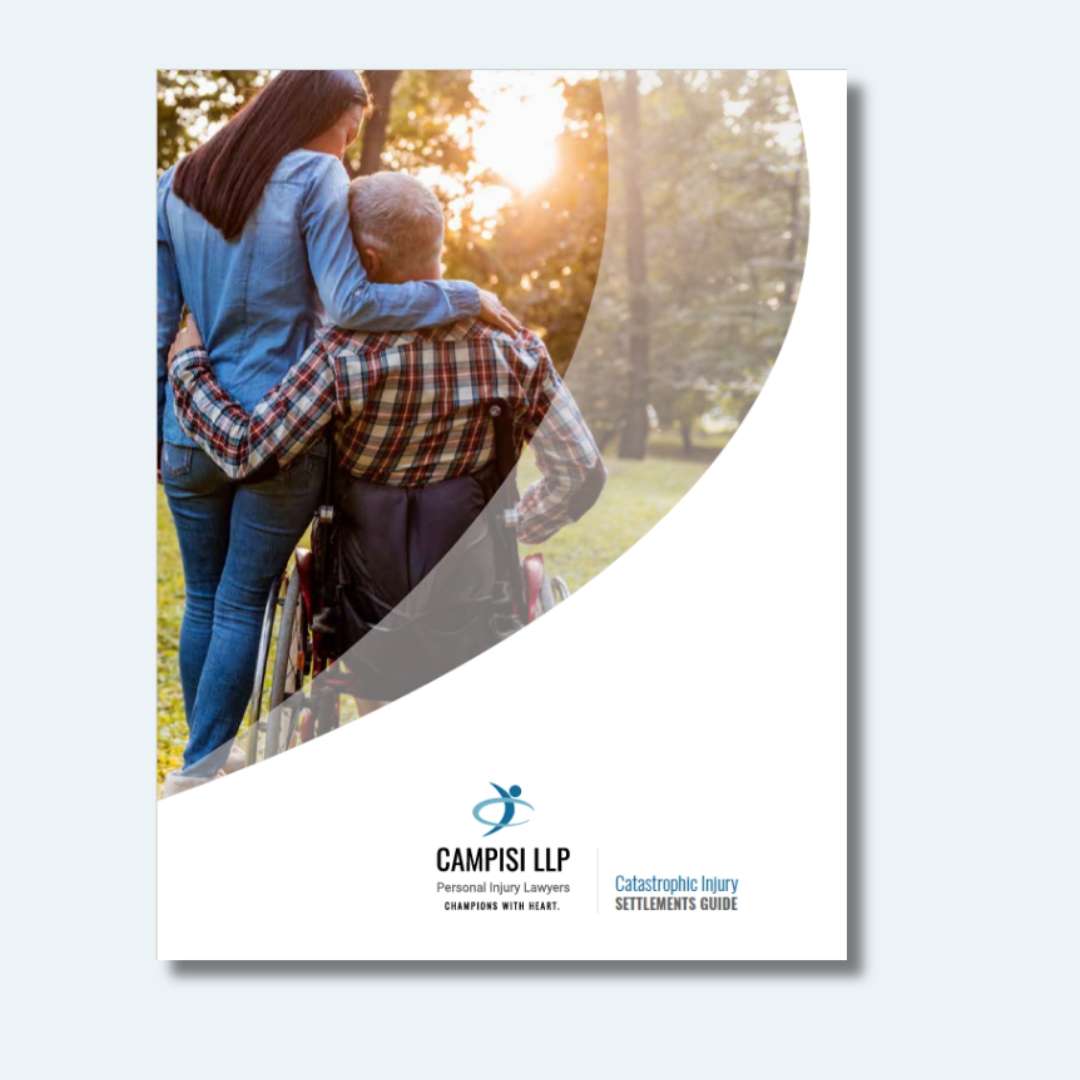 A woman is standing next to a man in a wheelchair.