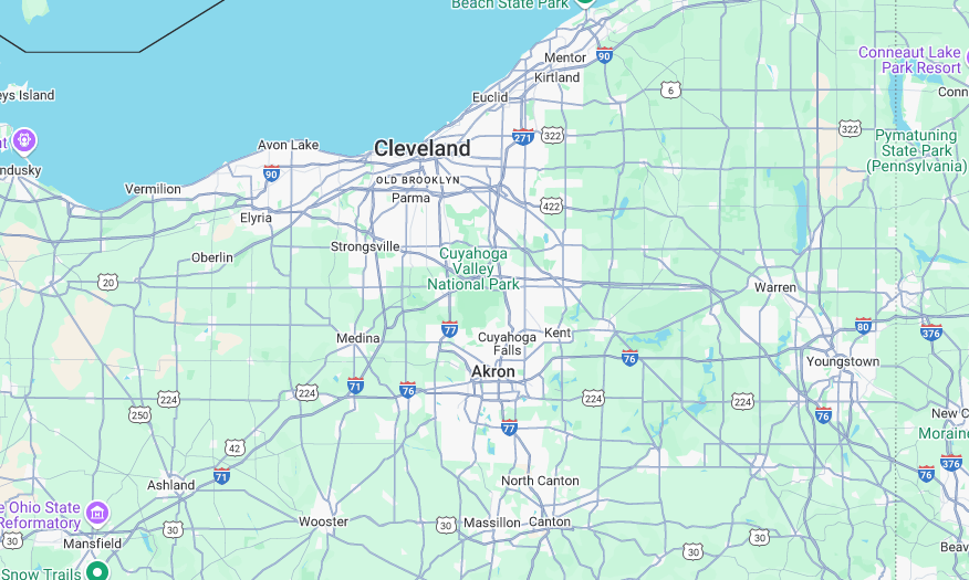 A man in a blue shirt is cleaning a window with a mop.