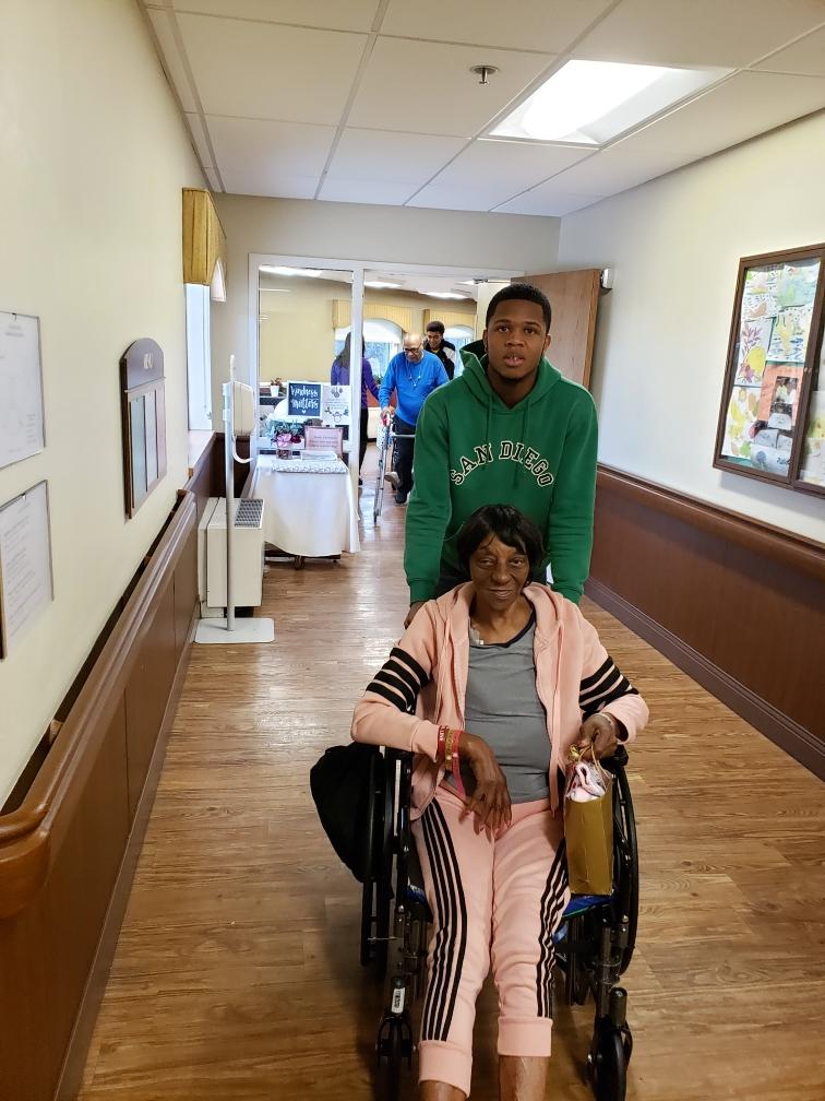 Student Athlete Helping Old Woman