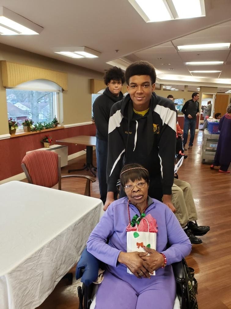 Student Athlete With Happy Old Woman