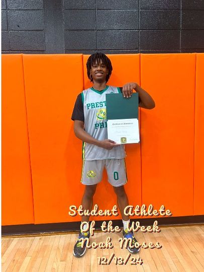 A man in a prestige jersey is holding a certificate