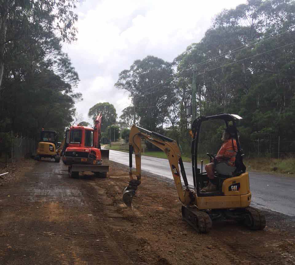 Excavators with man worki9ng — Drilling, exacavation and earthworks in Kiama, NSW